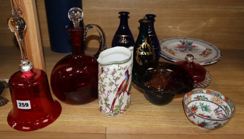 Three Regency gilt decorated blue glass spirit decanters, a Victorian cranberry glass hand bell and claret jug and various ceramics